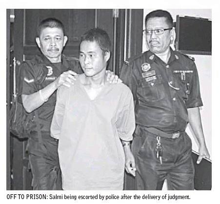 Salmi being escorted by police after the delivery of judgment