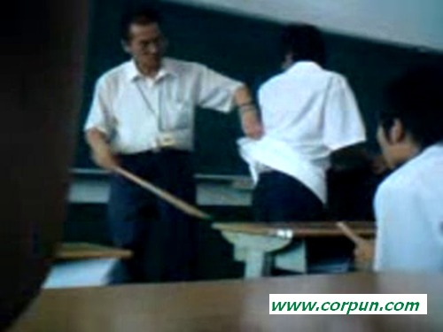 Schoolboy caned at teacher's desk